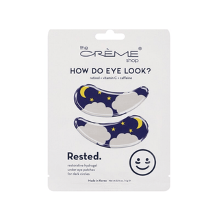 White packaging containing 'How Do Eye Look?' eye patches with clouds, moon and stars, by The Crème Shop on a white background.