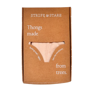 Brown cardboard box with 'Stripe & Stare' branding and tan thongs inside, on a white/grey background.