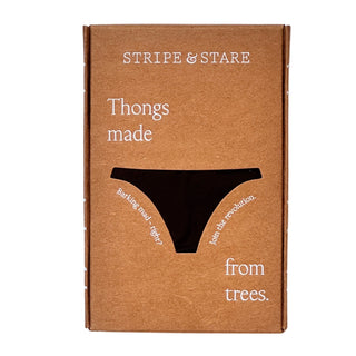 Brown box with 'Stripe & Stare' logo containing black lace trimmed thong. White/grey background.