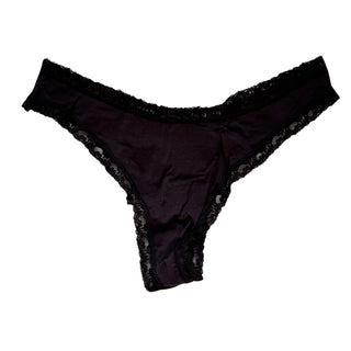 Black lace-trimmed thong underwear on a white background