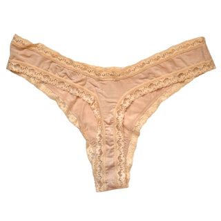 Back view of a beige lace thong on a white background